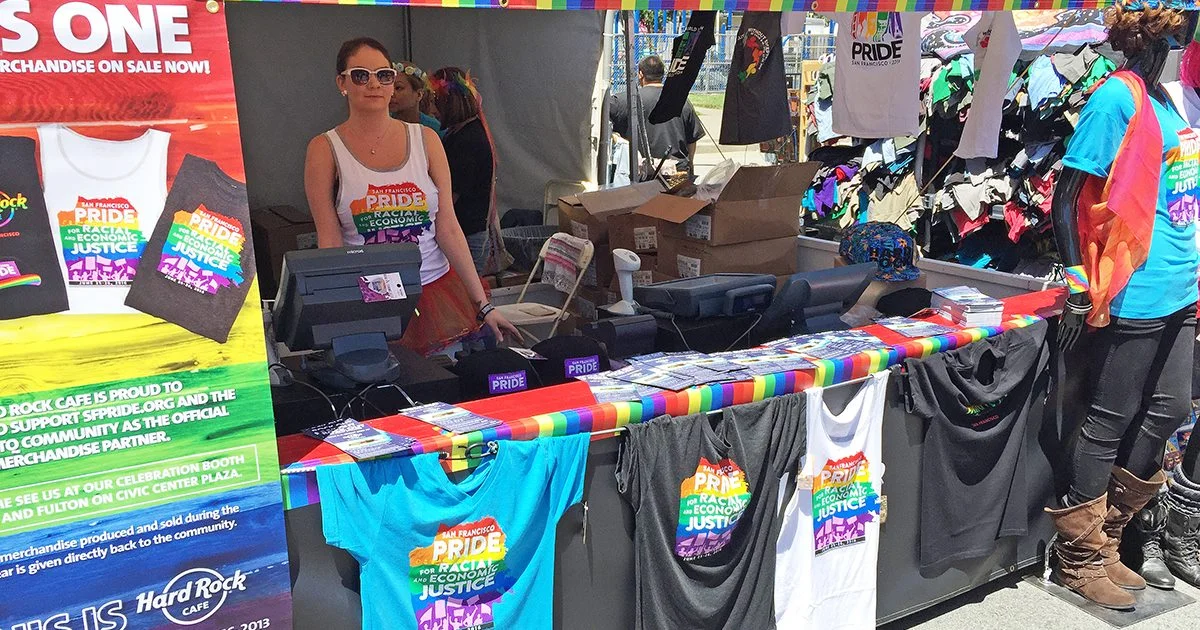 the sf pride merch booth from 2018, displaying different shirts for sale